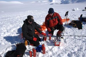 Test Your Limits team members sitting in the snow.