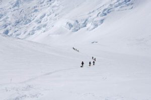 People in the distance walking in snow.