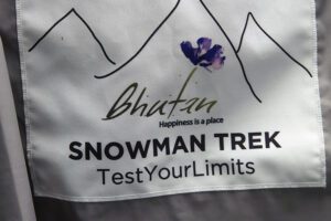 A flag with Bhutan, Snowman Trek, Test your Limits written on it.