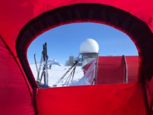 Shot of a domed building through a window in a tent in Greenland.