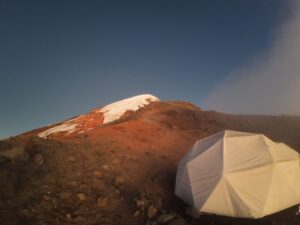 The Test Your Limits team camping at the summit of a mountain.