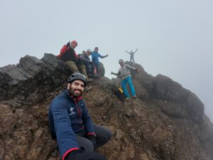 The Test Your Limits team at a summit of a mountain.