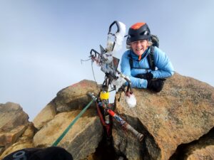 Dr. Ross hanging off a cliff.